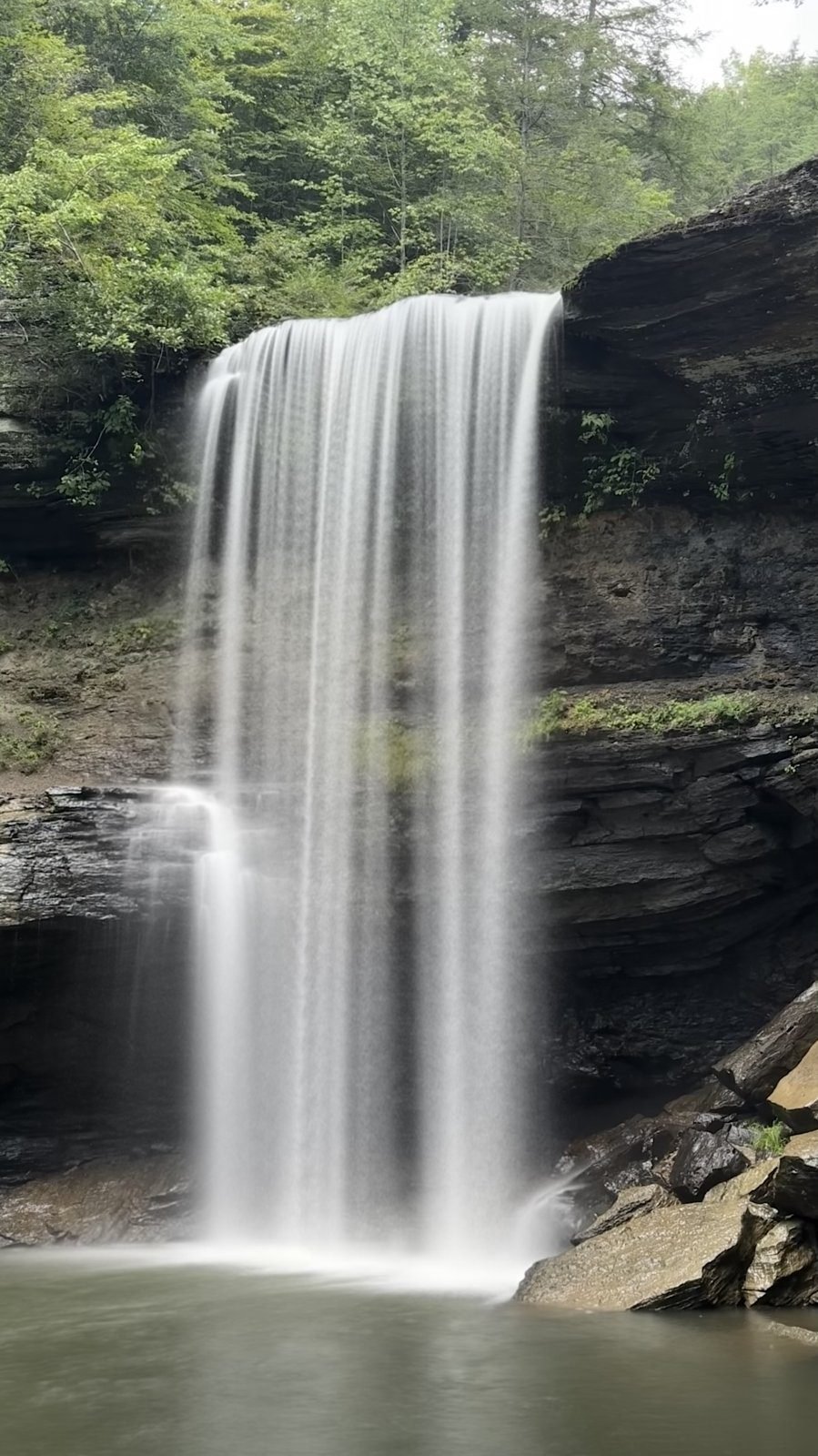 Lower Greeter Falls in Tennessee dropping over a sandstone ledge, photographed from the edge of the pool